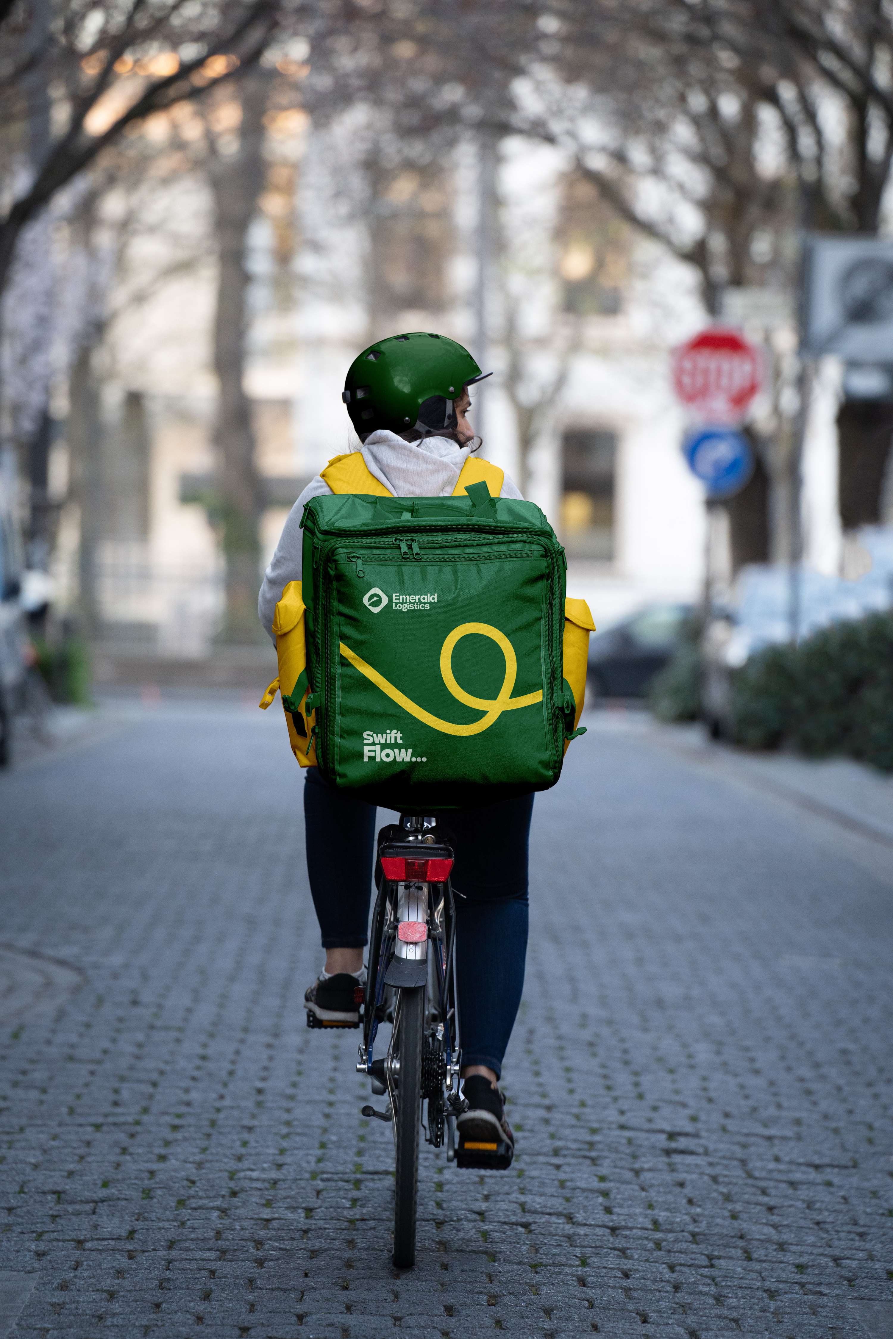 Emerald Logistics delivery rider on bicycle